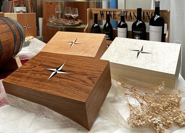 Ein Hängeschrank in geringer Tiefe in schwarz Hochglanz lackiert mit Griffdetail in Blattsilber und dekorativer Vase darauf.